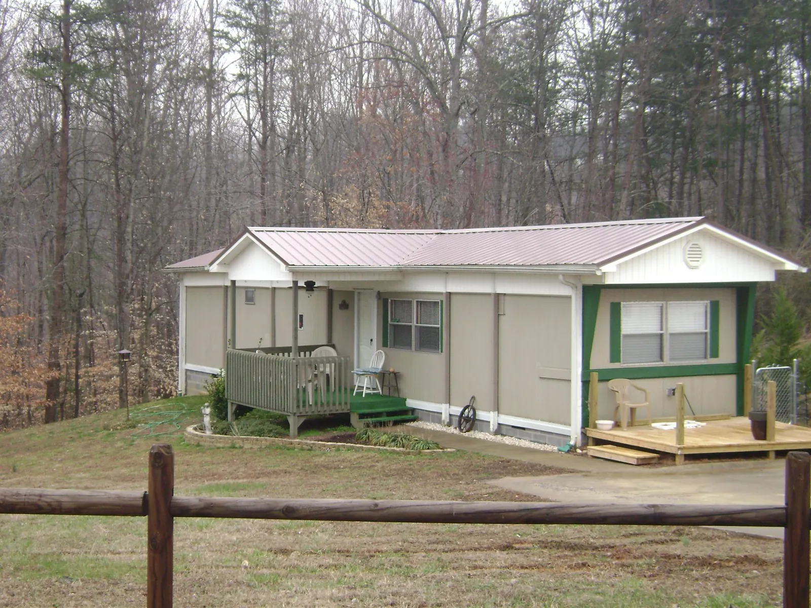 Mauve metal roof on a manufactured home with a new front deck in Snow Hill